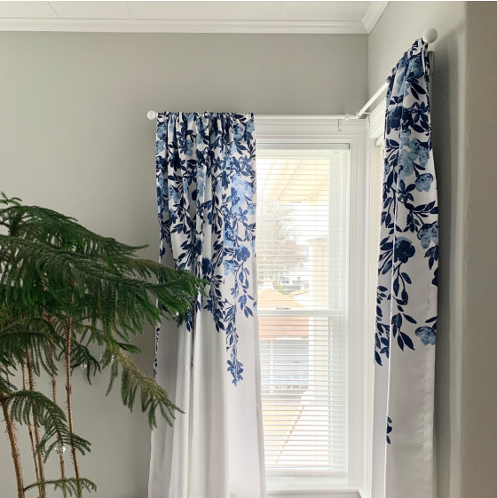 Floral curtains on a corner window hanged with Kwik-Hang